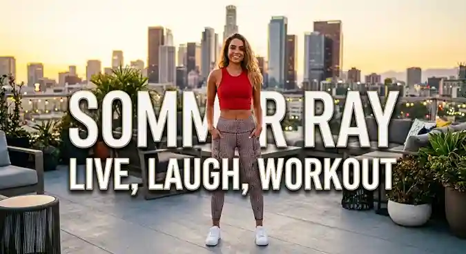 Sommer Ray standing straight outdoors against a city skyline with 'Sommer Ray' overlay text.